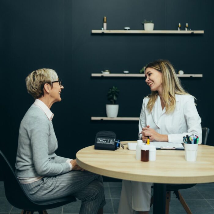 Female doctor in consultation with a senior woman patient
