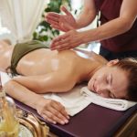Smiling Woman Enjoying Massage in SPA